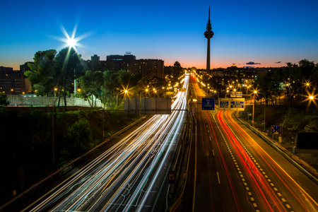 Sunset view of a Madrid skyline with the TorrespaÃ±a communications tower in the background and...
