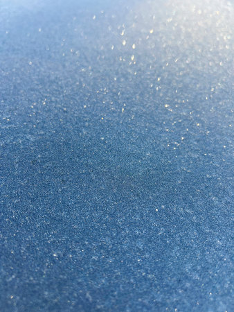 Ice crystals on a bluish surface with very shallow depth of field. Concept backgrounds and...