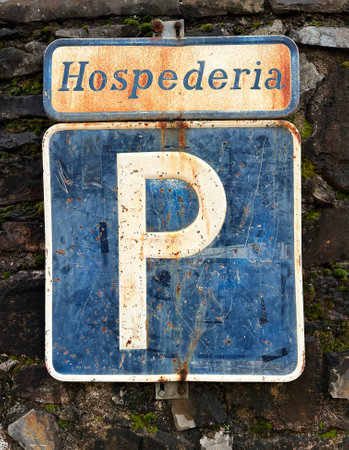 Parking indication sign in a Spanish hostelry, with a lot of texture and very aged by weathering.の写真素材