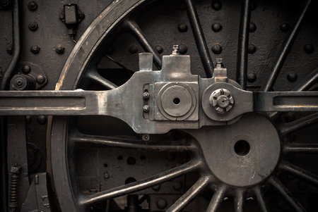 Old steam engine train wheels and parts close-up