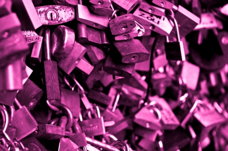 Love padlocks hanging on the fence, pink coloredのeditorial素材