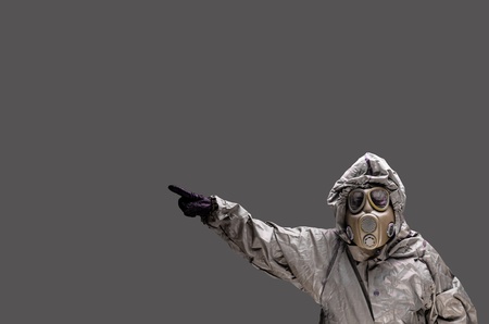 Man with a gas mask wearing hazmat suit in a studioの写真素材