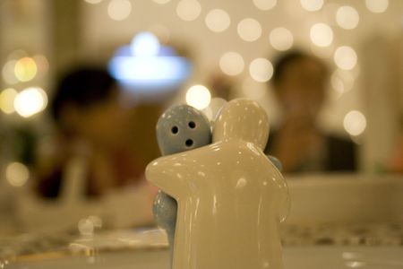 Figurines hugging on a dinner tableの写真素材