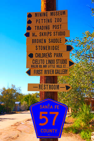 Tourist information sign with multiple destinations on the corner of Main and 1st in Los Cerrillos, NMのeditorial素材
