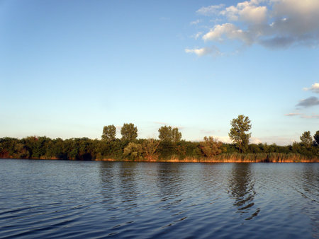 Autumn Colorful Trees ant the Blue River and Sky