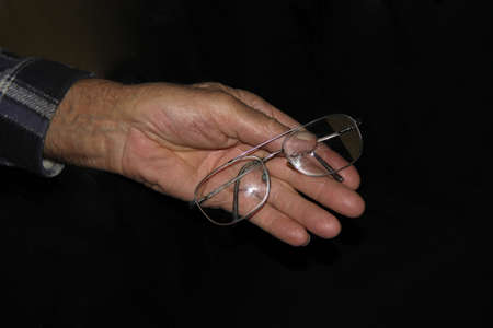 Glasses and senior man's handsの写真素材