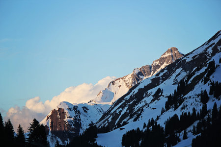 Blue Snowy Mountain Peaks with Clouds in Lec, Austria