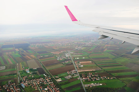 View from Airplane with Serbia Landscape. Agricultural Fields and Towns.