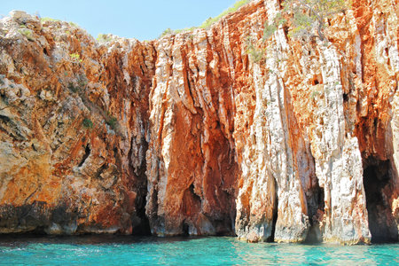 Red Rocks with Turquoise Sea in Hvar Island Dalmatia, Croatiaの写真素材