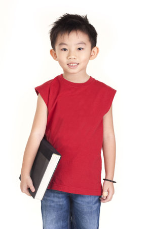 Chinese boy holding a bookの写真素材