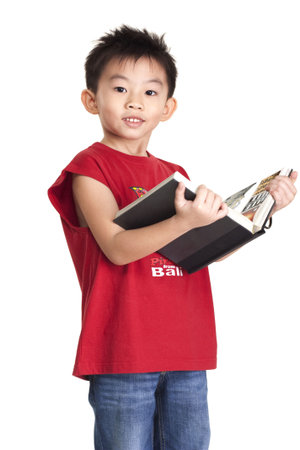 Chinese boy holding a bookの写真素材