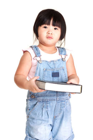 Cute little chinese girl holding a bookの写真素材