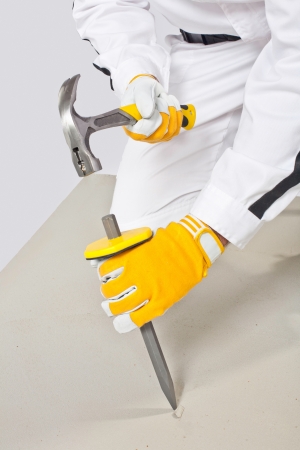 Worker with chisel and hammer check concrete baseの写真素材