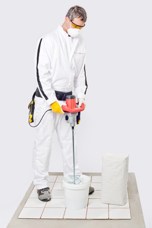Worker Mix Tile Adhesive With Machine Toolの写真素材