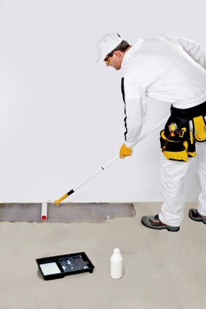 Worker Paint with Primer Concrete Floor for Waterproofingの写真素材
