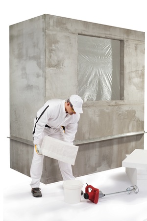 Worker pouring out an insulation adhesiveの写真素材