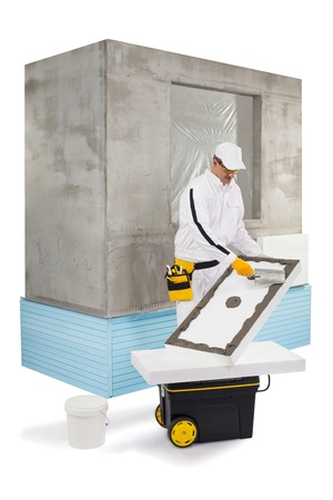 Worker spreading a putty with a trowelの写真素材