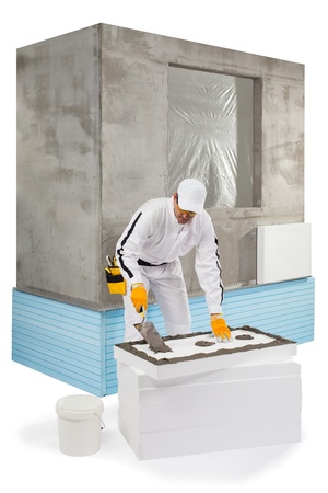 Worker spreading a lute on an insulation panelの写真素材