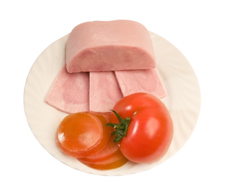 Ham  and tomato on white plateの写真素材