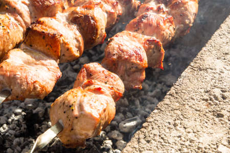 Cooking meat outdoors. Fried meat old recipe.の写真素材
