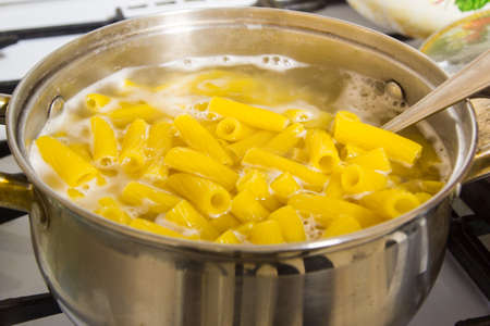Cooking pasta at home. Italian pasta cooked in salted water.の写真素材