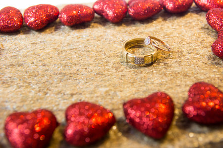 Wedding rings on a natural stone with inclusions of native gold. Offer hands and hearts