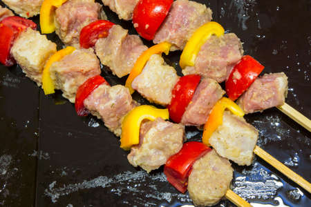 Kebab with vegetables. Meat with tomatoes and peppers on bamboo skewers.の写真素材