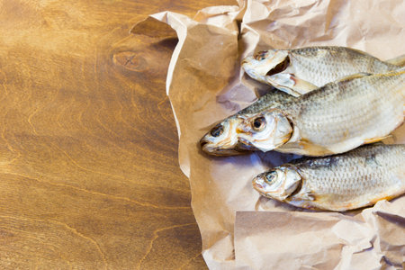 Traditional Russian snacks to beer. Dried roach on paper.の写真素材