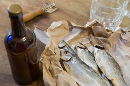 Traditional Russian snacks to beer. Dried roach on paper.の写真素材
