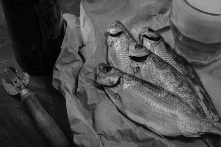 Traditional Russian snacks to beer. Dried roach on paper.の写真素材