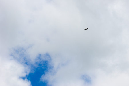Cloudy sky. The plane flies into the distance.