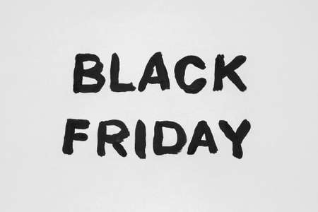 The inscription on a white sheet of paper. Black Friday. A 50% discount. Sale. The inscription paintedの写真素材