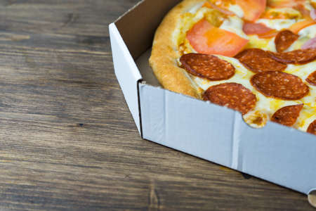 Pizza to order. Pizza in a cardboard box.の写真素材
