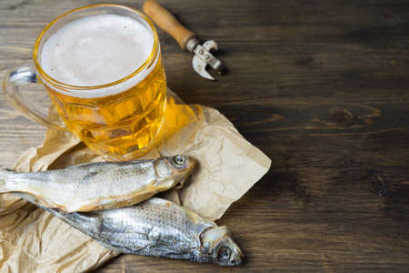 Traditional Russian snacks to beer. Dried roach on paper.の写真素材