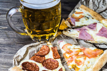 Light beer in glass and fragrant Italian pizza.の写真素材