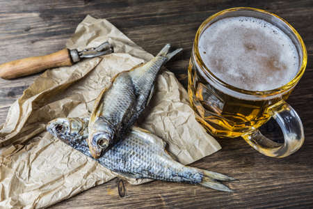 Traditional Russian snacks to beer. Dried roach on paper.の写真素材