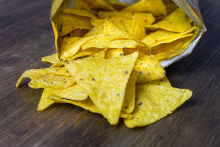 Nachos corn chips with classic tomato salsa. Fresh cold beer is perfect with savory snacks.の写真素材