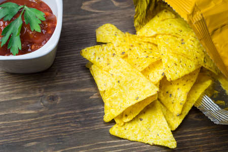 Nachos corn chips with classic tomato salsa. Fresh cold beer is perfect with savory snacks.の写真素材