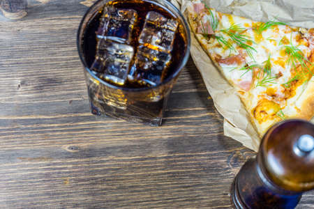 Delicious pizza with a glass of cold Cola with ice.の写真素材