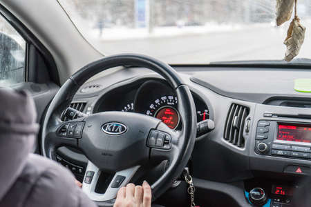 Belgorod, Russia-February 11, 2018: man driving a KIA. Photo steering the car close-upのeditorial素材