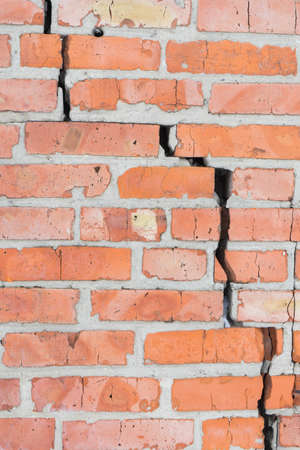 Old brick wall with cracks. Wall of red brick.の写真素材