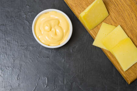 Cheese sauce on a black background. Place for your text...の写真素材