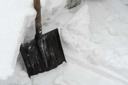 Remove snow with a shovel. Place for your text...の写真素材