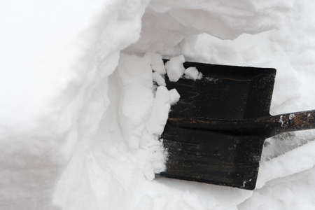 Remove snow with a shovel. Place for your text...の写真素材