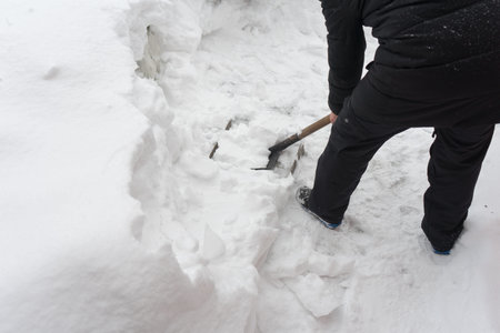 Remove snow with a shovel. Place for your text...の写真素材
