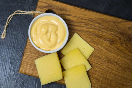 Cheese sauce on a black background. Place for your text...の写真素材
