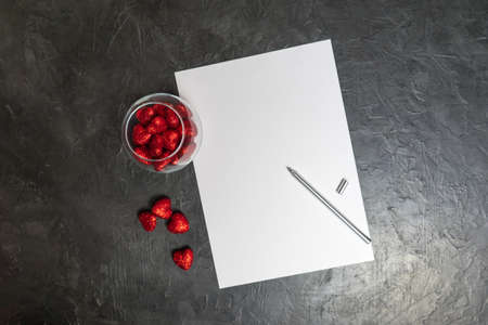 A blank sheet of paper on a dark background. Love letter. Place for your text...の写真素材