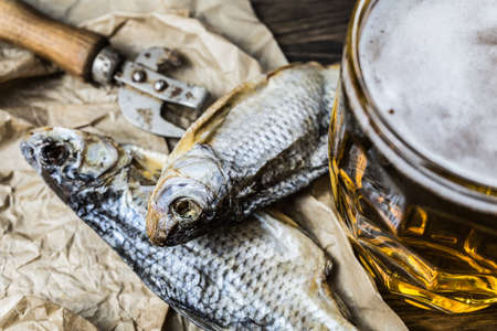 Traditional Russian snacks to beer. Dried roach on paper.の写真素材