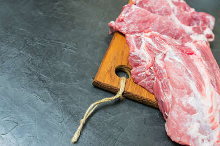 Raw meat on a cutting Board. place for your text...の写真素材