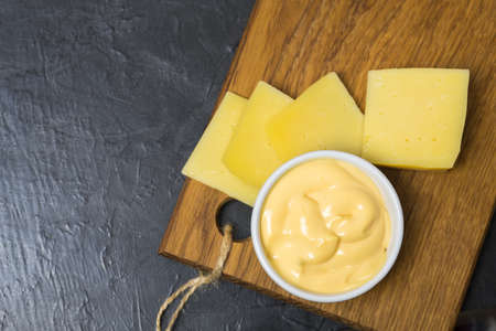 Cheese sauce on a black background. Place for your text...の写真素材
